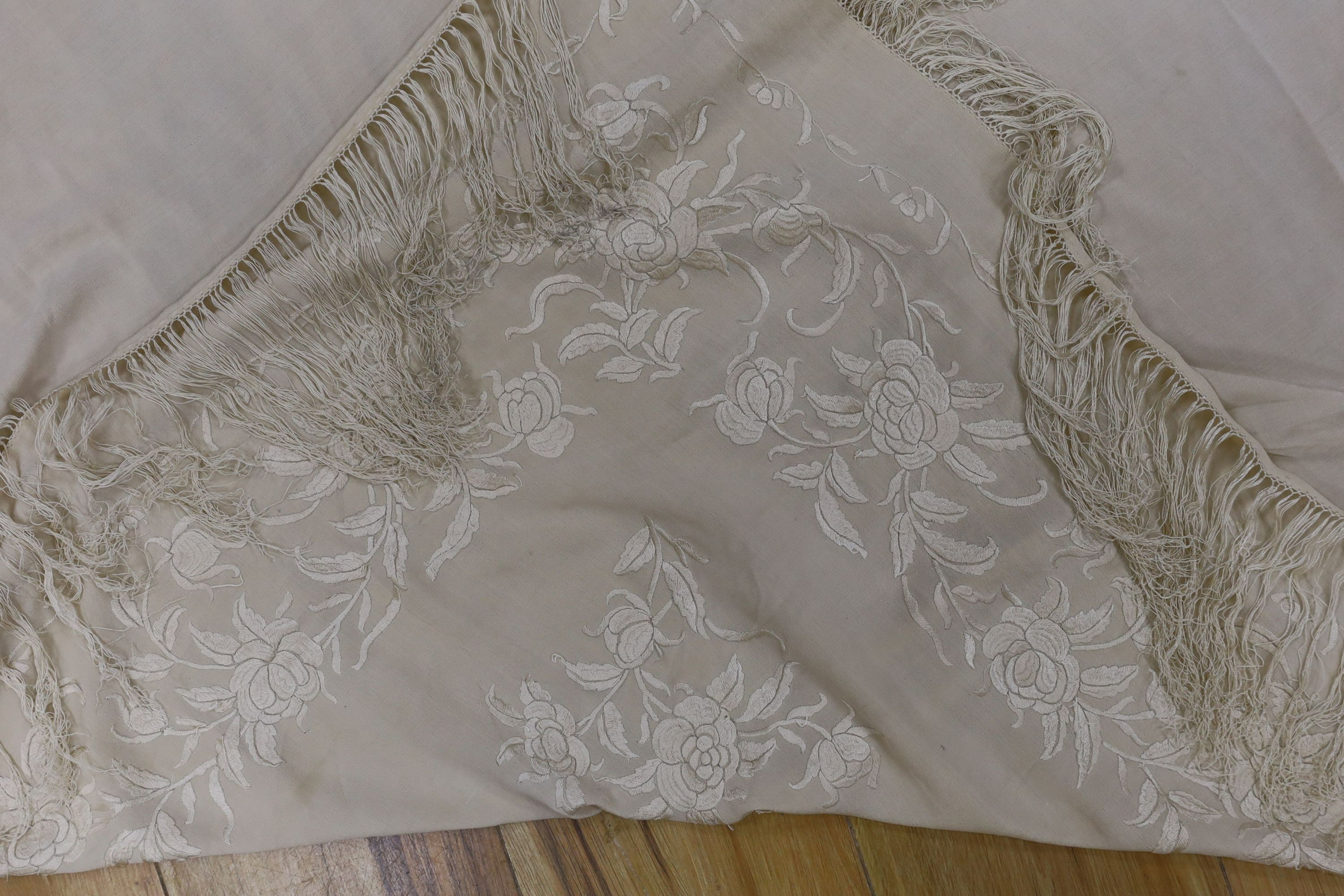 A 19th century cream embroidery on cream silk shawl together with a smaller later shawl